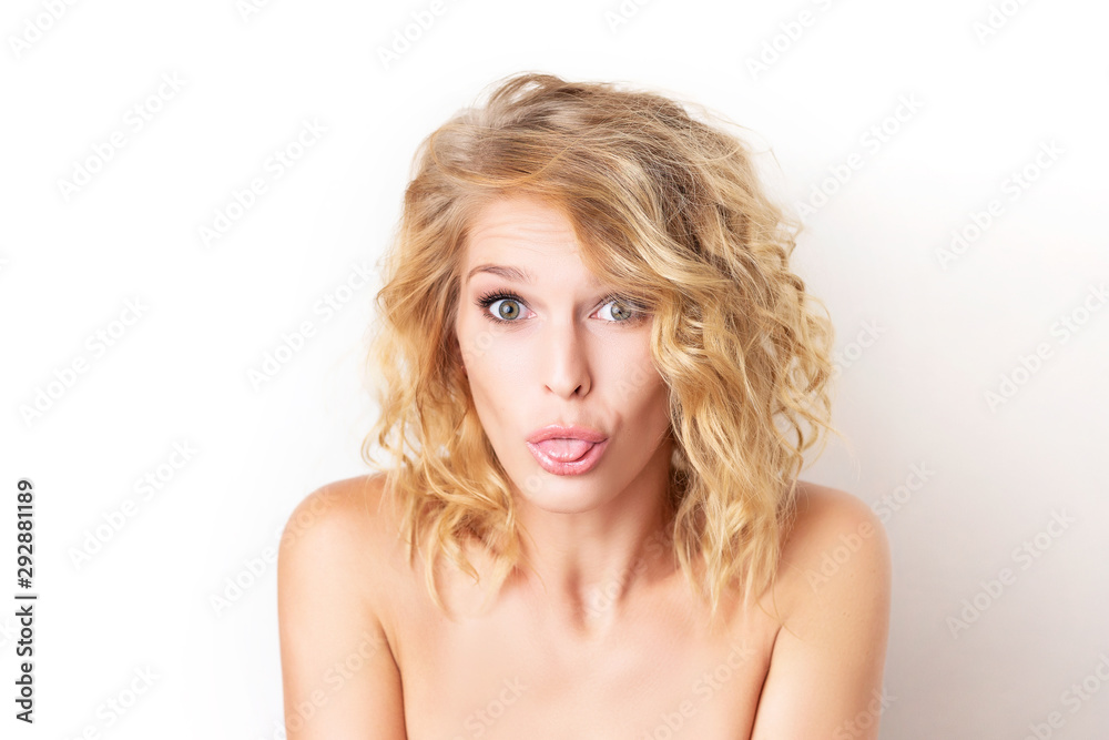 Closeup portrait of a woman with foolish grimace showing tongue isolated at white background. Concepy of joy and careless lifestyle. Funny emotion. Closeup portrait of a woman with foolish grimace showing tongue isolated at white background. Concepy of joy and careless lifestyle. Funny emotion.