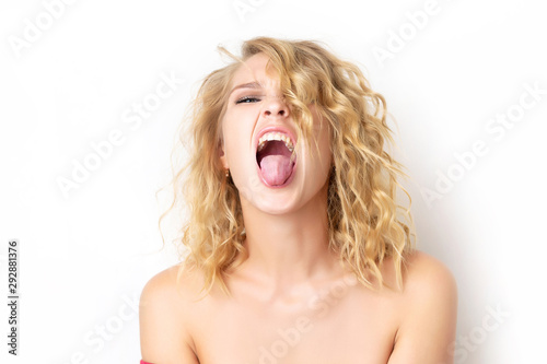 |Portrait of a woman with foolish grimace showing tongue and teasing isolated at white background. Concept of joy crazy lifestyle. Funny emotion.