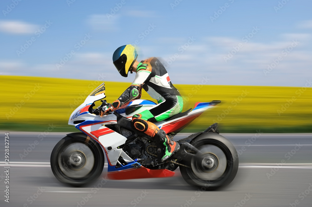 Racing bike rider racing at high speed on a colorful background