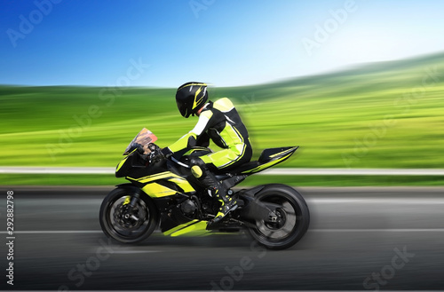 Motorcycle rider racing at high speed on a colorful background