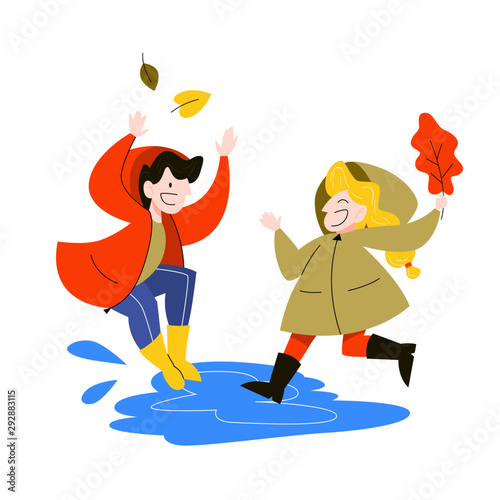 Happy children jump in the puddle under the rain