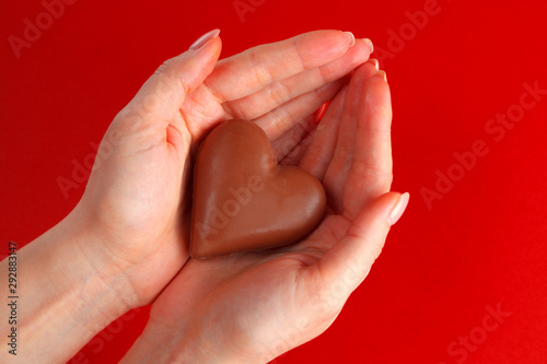 chocolate heart in the palms