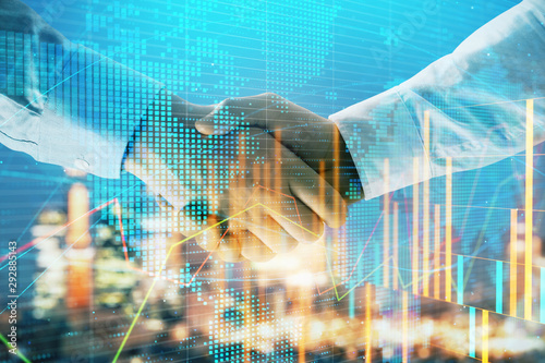 Wallpaper Mural Double exposure of financial chart and world map on cityscape background with two businessmen handshake. Concept of international investment Torontodigital.ca