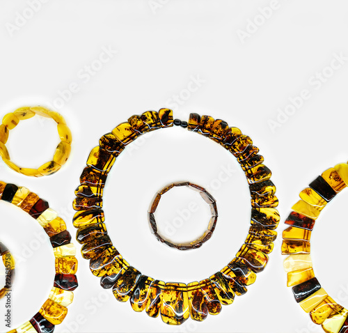 Amber neklaces and blacelets on a white background photo