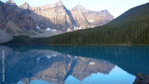 Landscape view of the Moriane Lake -one of the most famous lake in Canada- in the early morning with reflection of the rockie mountain range on the lake's surface in Banff national park,Alberta,Canada photo