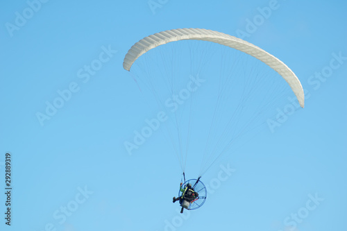 Paraglider in the blue sky