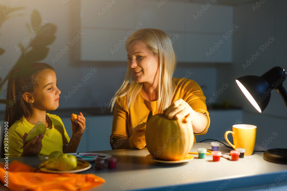 Mother and daughter pumpkin carving at home Mother and daughter pumpkin carving at home