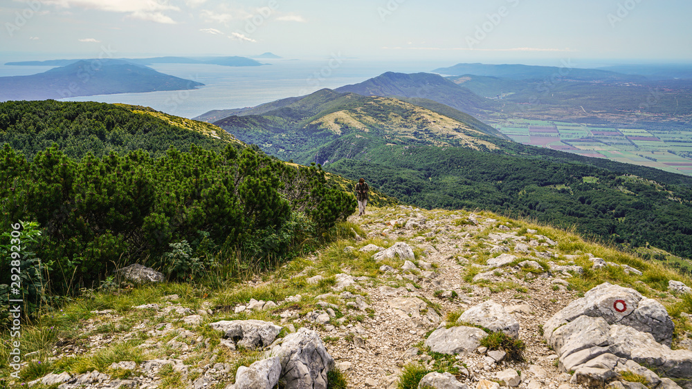 Walking along a hiking trail on the top of Mount Voyak, Istria. The islands of Krk and Cres are visible on the left