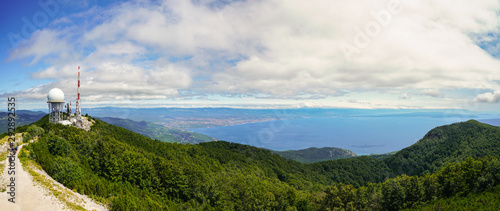 Fototapeta Naklejka Na Ścianę i Meble -  Meteorological and telecommunications equipment on Mount Vojak. In the distance are the cities of Opatija and Rijeka, the islands of Krk, Cres, Plavnik