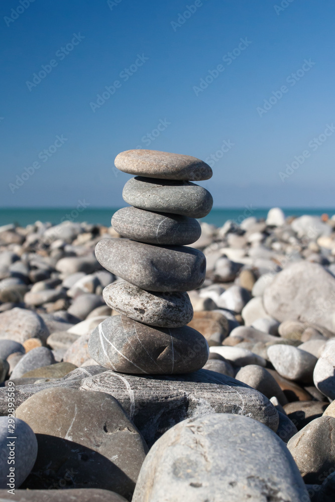 Stones balance, pebbles stack over blue sea . Stones balance, pebbles stack over blue sea .