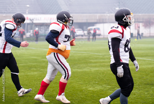 confident American football players leaving the field