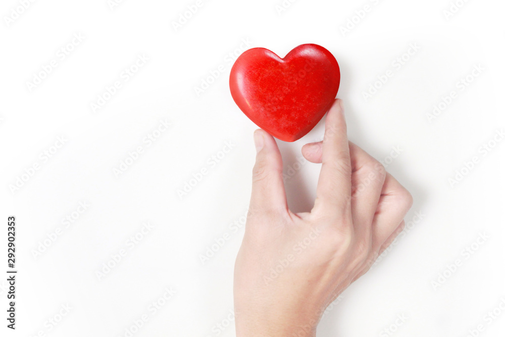 Hands holding  red heart, heart health, and donation concepts...