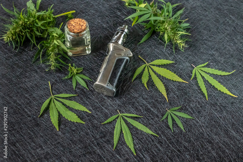 Vape CBD or THC, Vaping Marijuana and Hemp. Against a Dark Background