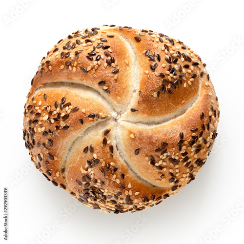 Traditional white kaiser roll with linseeds and sesame seeds isolated on white. Top view. photo