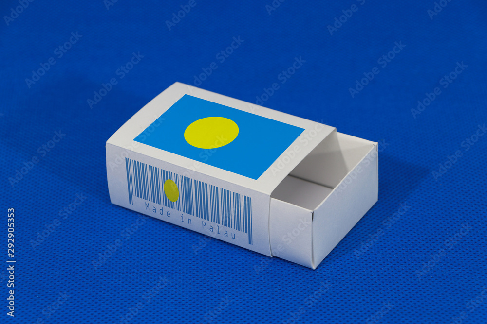 Fototapeta premium Palau flag on white box with barcode and the color of nation flag on blue background, paper packaging for put match or products.