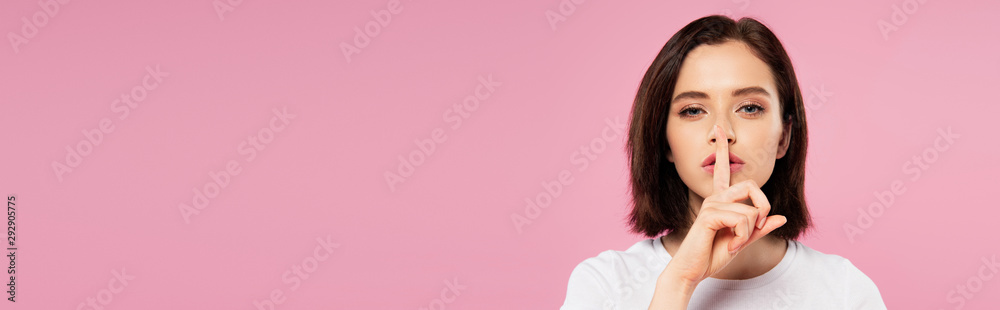 panoramic shot of beautiful girl showing hush sign isolated on pink panoramic shot of beautiful girl showing hush sign isolated on pink