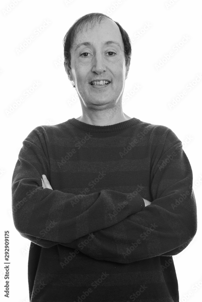 Studio shot of happy mature man smiling with arms crossed Studio shot of happy mature man smiling with arms crossed