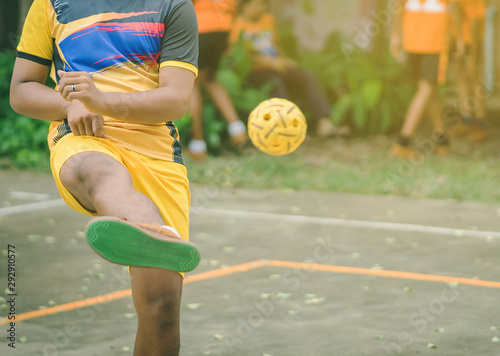 Students playing traditional asian sport game sepak takraw in school
