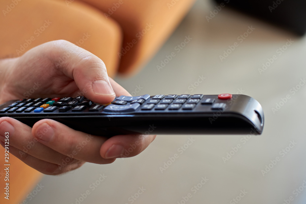 Hand holding remote control that is used. Hand holding remote control that is used.