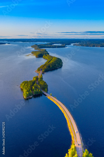Aerial view of Pulkkilanharju Ridge, Paijanne National Park, southern part of Lake Paijanne. Landscape with drone. Blue lakes, road and green forests from above on a sunny summer day in Finland.
