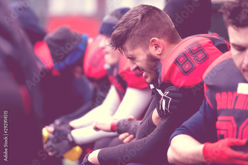 Fényképezés american football player holding the injured shoulder