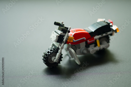 Red motorcycle toy plastic toy the realistic motocross bike studded tires photo