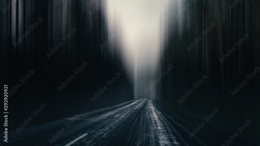 asphalt road in a gloomy surreal forest. highway in a gloomy eerie landscape.