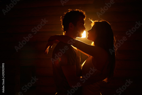 young couple in love. Kissing man and woman at home in intimate atmosphere.