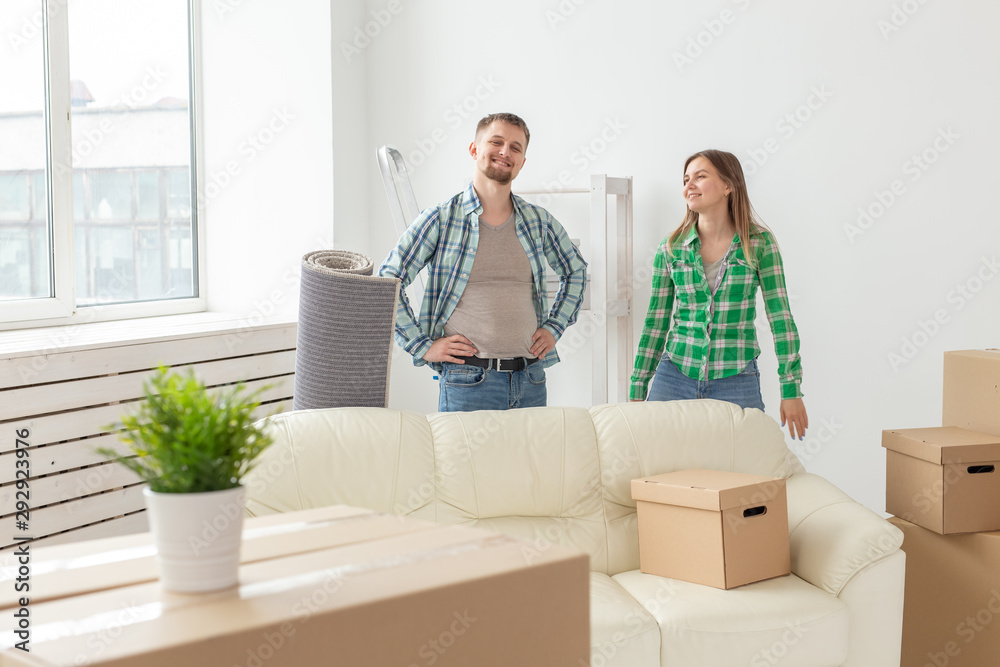 Family, new apartment and relocation concept - Young couple moving in new house Family, new apartment and relocation concept - Young couple moving in new house