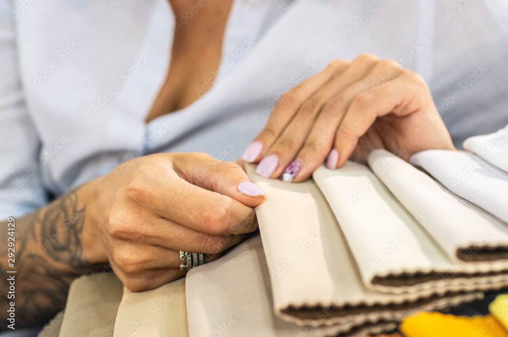 A young women looks at tissue samples. Selects the color of the sofa. 