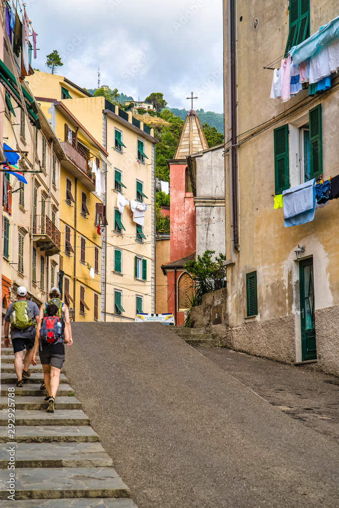 Riomaggiore, Cinque Terre, Italy - August 17, 2019: City narrow streets with colorful houses, a resort town in Europe on the shore of the Ligurian Sea