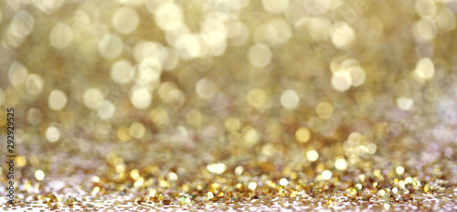 Gold glitter shine dots confetti. Abstract light blur blink sparkle defocus backgound. photo