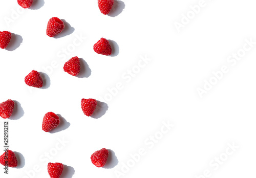 Raspberries frame with shadows on the white background. Top view. Copy space
