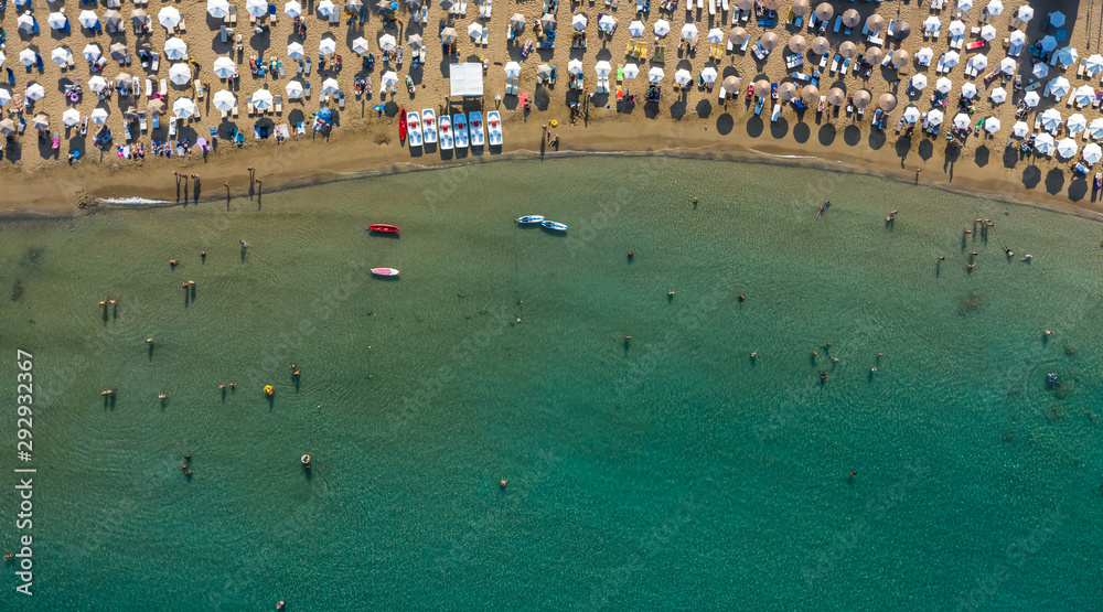 AERIAL. Summer beach with people and turquoise ocean water from top point of view,