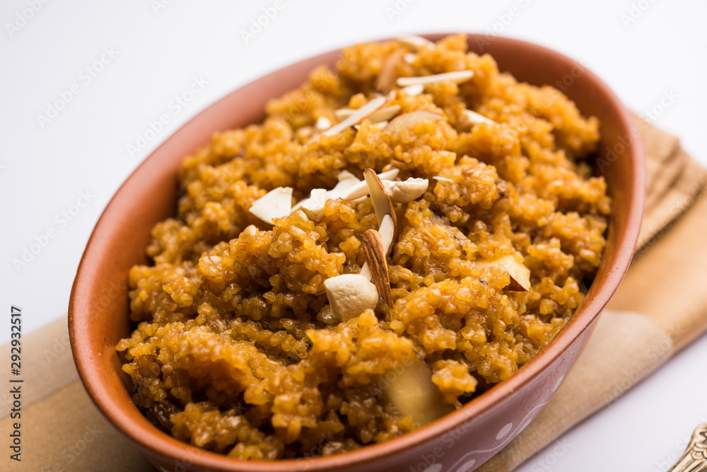 Wheat Laapsi/Lapsi/Shira/Halwa is an Indian sweet dish made of broken wheat or Daliya pieces and ghee along with nuts, raisins and dried fruits. It's a healthy food. served in a bowl, selective focus Wheat Laapsi/Lapsi/Shira/Halwa is an Indian sweet dish made of broken wheat or Daliya pieces and ghee along with nuts, raisins and dried fruits. It's a healthy food. served in a bowl, selective focus