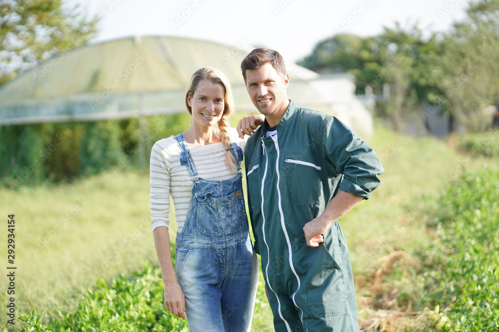 Couple of farmers standing in agricultural field Couple of farmers standing in agricultural field
