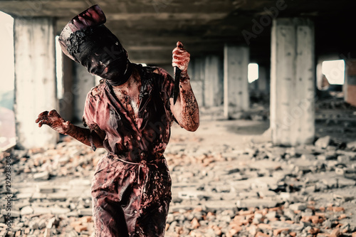 Ghost nurse woman or zombie holding the knife with resentment and malice in the building abandoned hospital. photo