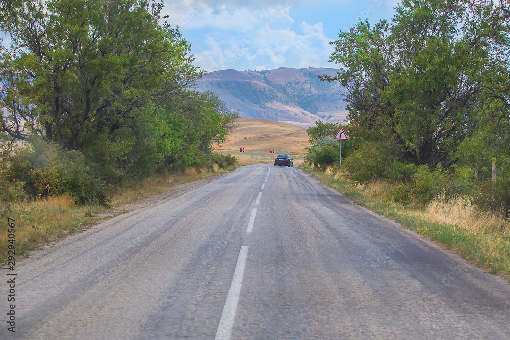 Car Moves along a winding road in the mountains during