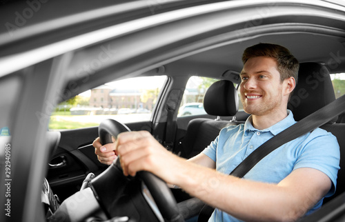 transport, vehicle and people concept - smiling man or driver driving car in summer