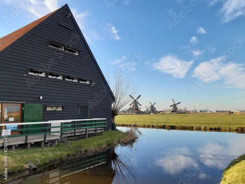 The Dutch Dutch suburb of Zaansche Schans. The water channels, the serene climate and the typical windmills. photo