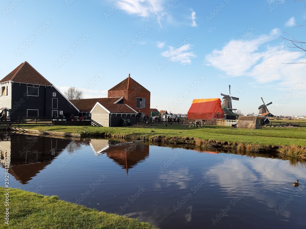 The Dutch Dutch suburb of Zaansche Schans. The water channels, the serene climate and the typical windmills. The Dutch Dutch suburb of Zaansche Schans. The water channels, the serene climate and the typical windmills.