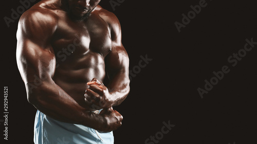 Strong biceps and chest of black bodybuilder photo