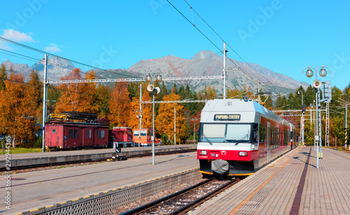 Red train on rail station near Strbske pleso lake in Slovak Tatras
