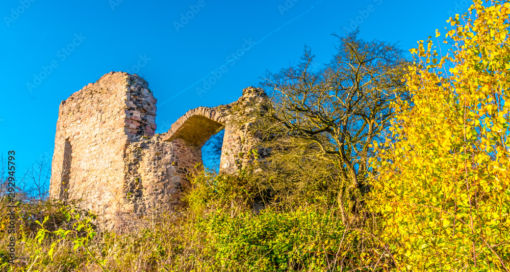 The castle Frauenberg im is the ruin of a medieval hilltop castle near Beltershausen near Marburg. It is autumn with sun and blue sky.