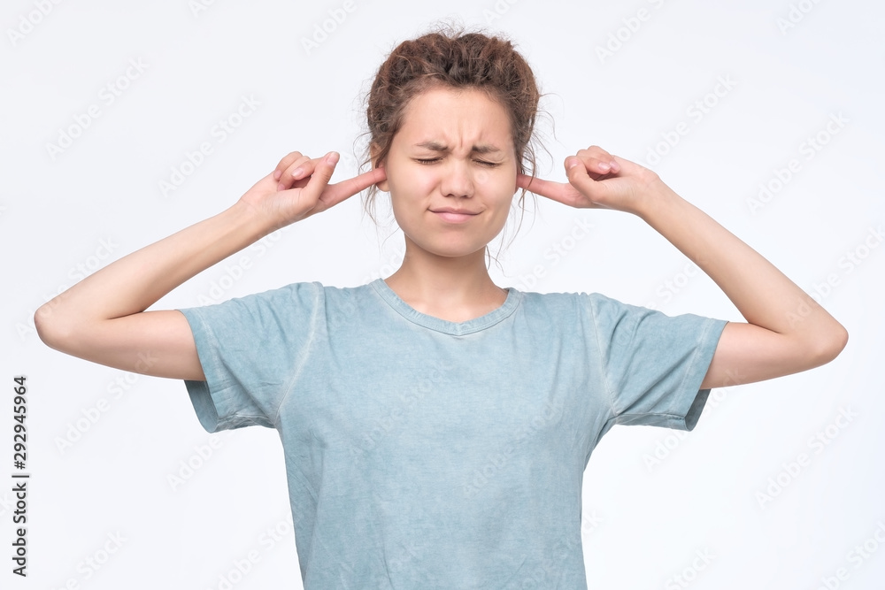 woman plugging ears, pretending not to hear what she is told. woman plugging ears, pretending not to hear what she is told.