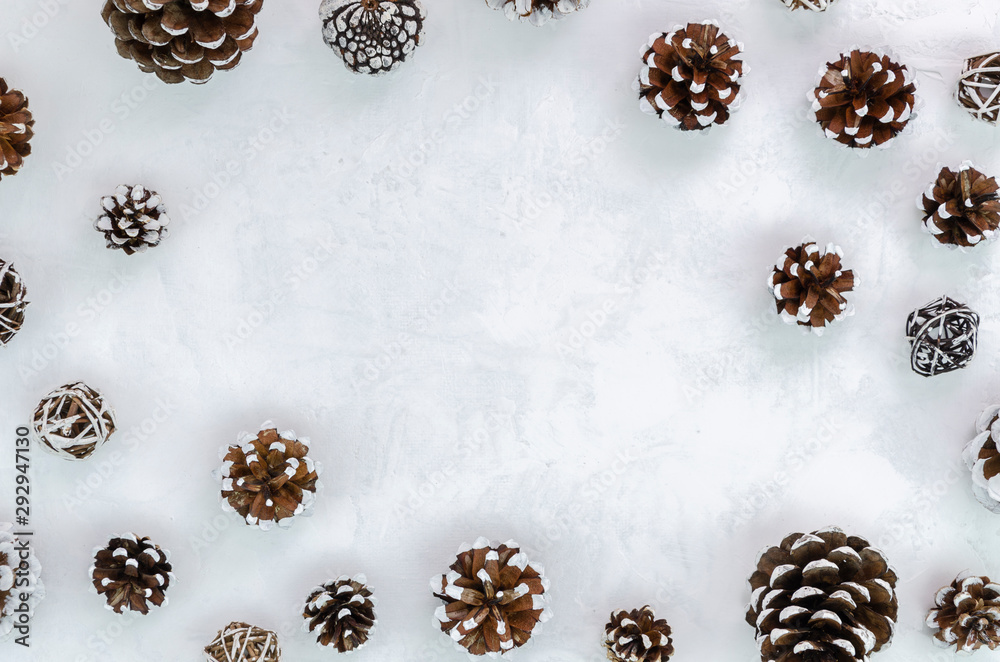 Christmas minimal frame concept. Pinecones on white background border composition. Copy space for text Christmas minimal frame concept. Pinecones on white background border composition. Copy space for text