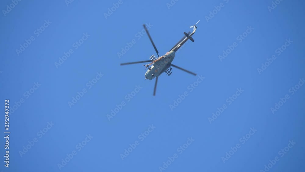 Brave skydiver jumping out of a helicopter with an opening white parachute Brave skydiver jumping out of a helicopter with an opening white parachute