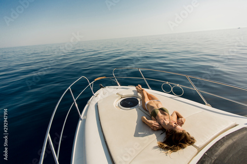 Pretty young woman on the yacht at summer