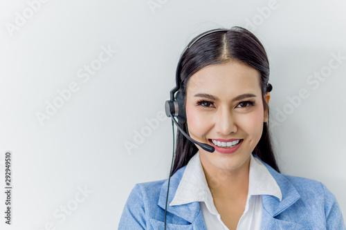 Business call center customer support - Beautiful Asian female staff operator wearing headphone with microphone on white background. 