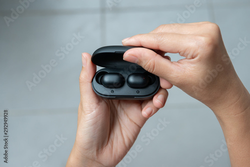 Wallpaper Mural Close up of woman is open the black true wireless earbuds case Torontodigital.ca